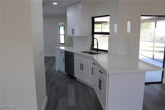 kitchen featuring kitchen peninsula, white cabinetry, stainless steel dishwasher, and decorative light fixtures