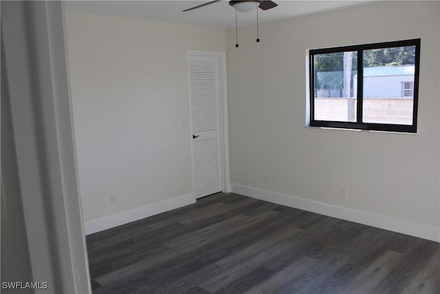 unfurnished room featuring ceiling fan and dark hardwood / wood-style floors