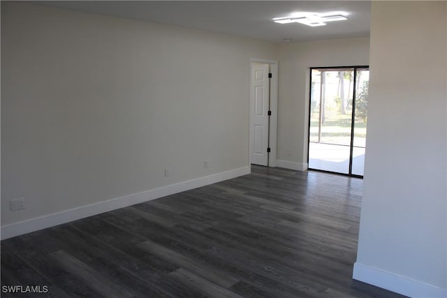 empty room with dark wood-type flooring