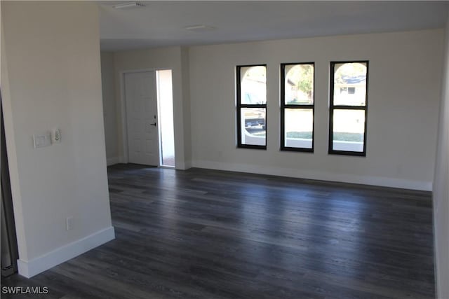 empty room featuring dark hardwood / wood-style flooring