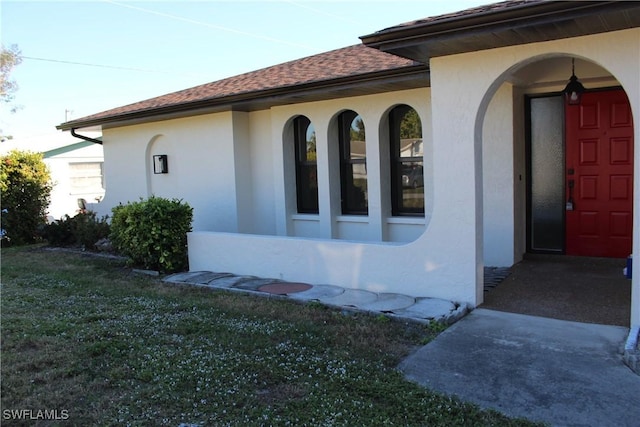 view of side of property with a lawn