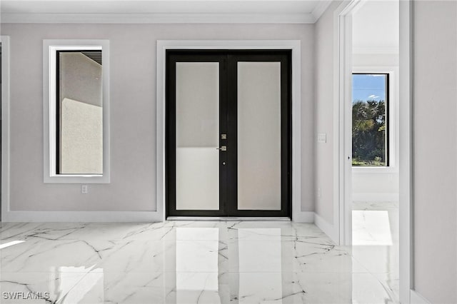 foyer with ornamental molding and french doors