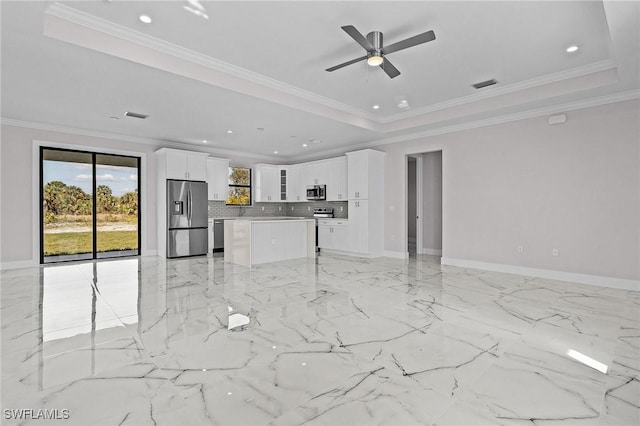 unfurnished living room with ornamental molding, a raised ceiling, and ceiling fan