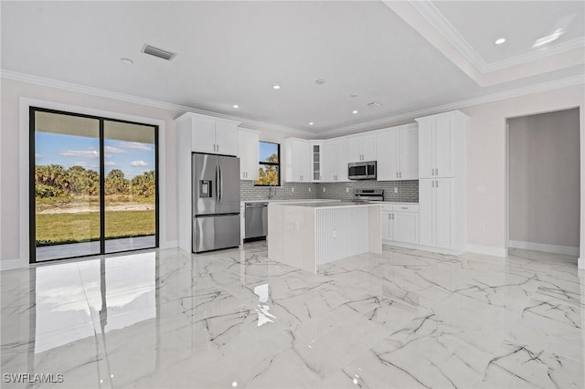 kitchen featuring white cabinetry, tasteful backsplash, a center island, and appliances with stainless steel finishes