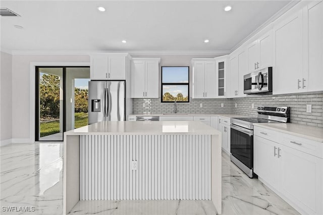 kitchen featuring white cabinetry, stainless steel appliances, and a center island