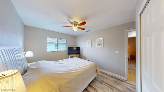 bedroom with light hardwood / wood-style floors and ceiling fan