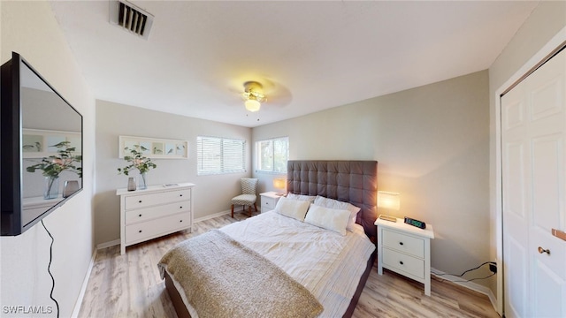 bedroom with a closet, ceiling fan, and light hardwood / wood-style flooring