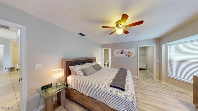 bedroom with a closet, light hardwood / wood-style floors, a spacious closet, and ceiling fan