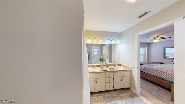 bathroom with ceiling fan and vanity