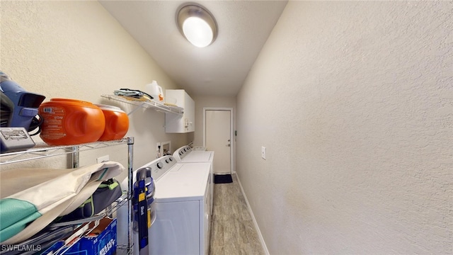 laundry area with light hardwood / wood-style floors and independent washer and dryer