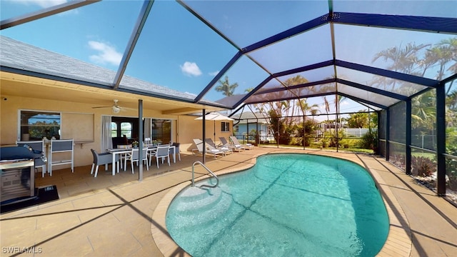 view of swimming pool featuring a lanai, ceiling fan, and a patio area