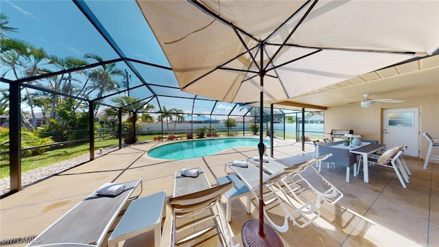 view of pool featuring ceiling fan, a patio area, and glass enclosure