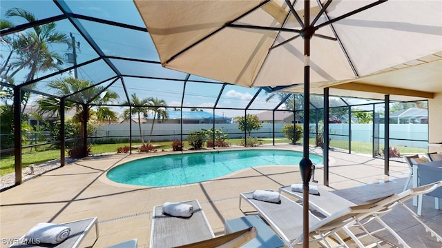 view of swimming pool featuring a lanai and a patio area