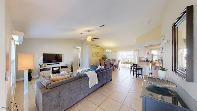 tiled living room with ceiling fan and vaulted ceiling