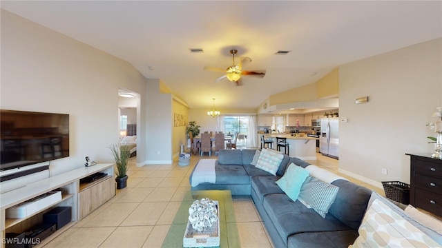 tiled living room featuring ceiling fan and lofted ceiling