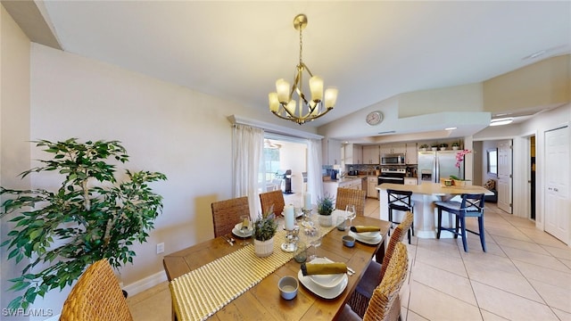 dining room with light tile patterned floors, vaulted ceiling, and a notable chandelier