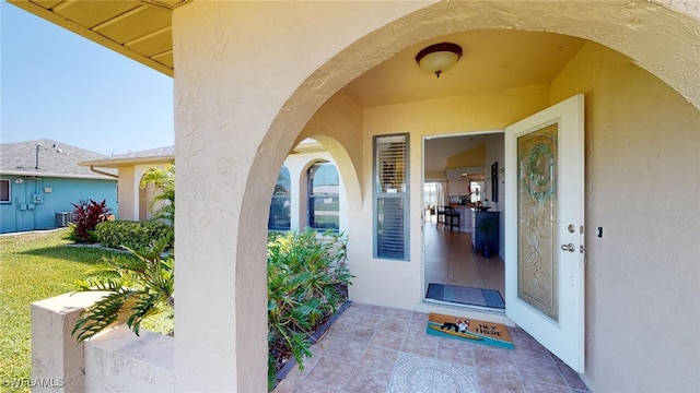 doorway to property featuring a lawn