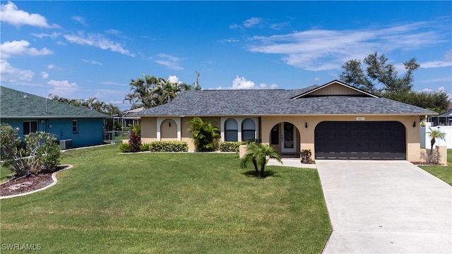 single story home with central AC unit, a front lawn, and a garage