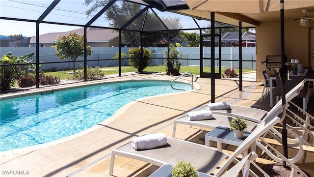 view of swimming pool featuring glass enclosure, a mountain view, and a patio