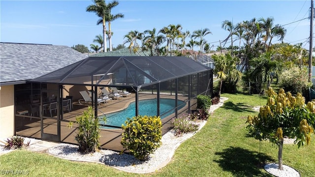 view of pool featuring a lawn, a lanai, and a patio