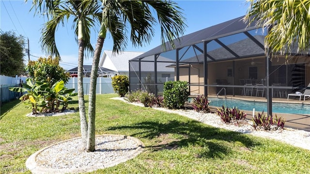 view of swimming pool featuring glass enclosure and a lawn