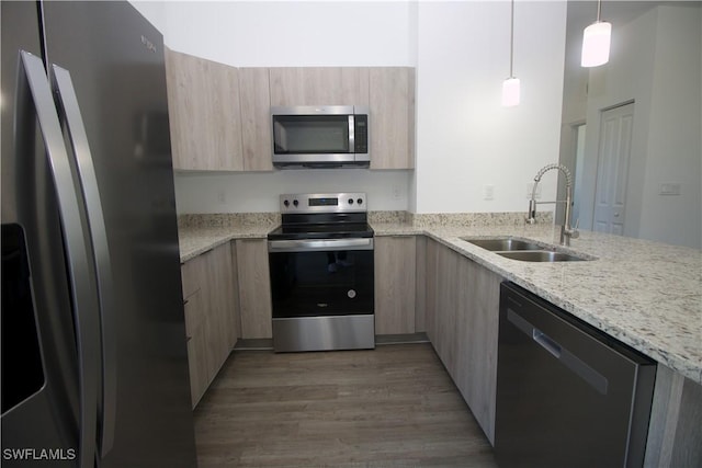 kitchen with light brown cabinetry, sink, stainless steel appliances, and dark hardwood / wood-style floors