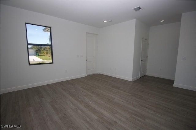 unfurnished room with dark hardwood / wood-style floors