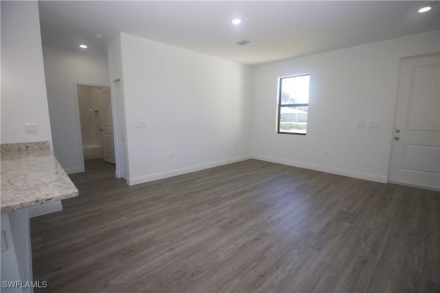 unfurnished room featuring dark wood-type flooring