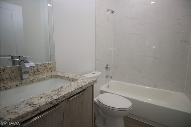 full bathroom with toilet, vanity, and tiled shower / bath