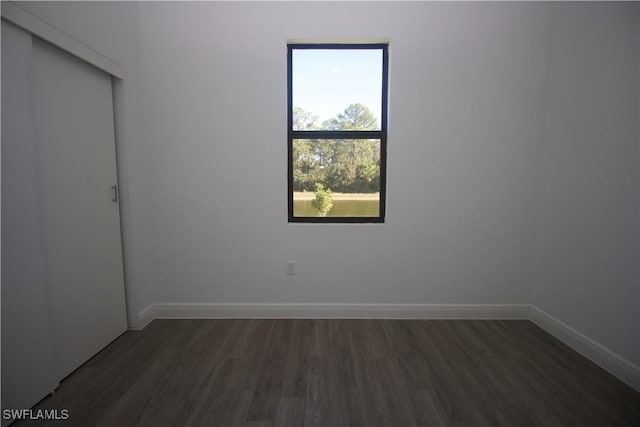 empty room featuring dark wood-type flooring