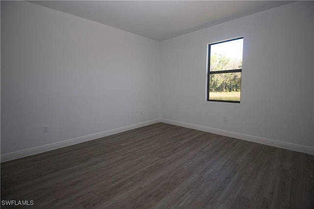 spare room featuring dark wood-type flooring