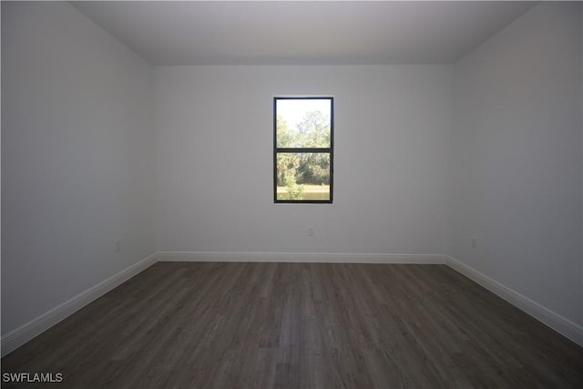 unfurnished room featuring dark hardwood / wood-style floors