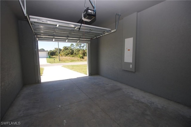 garage featuring electric panel and a garage door opener