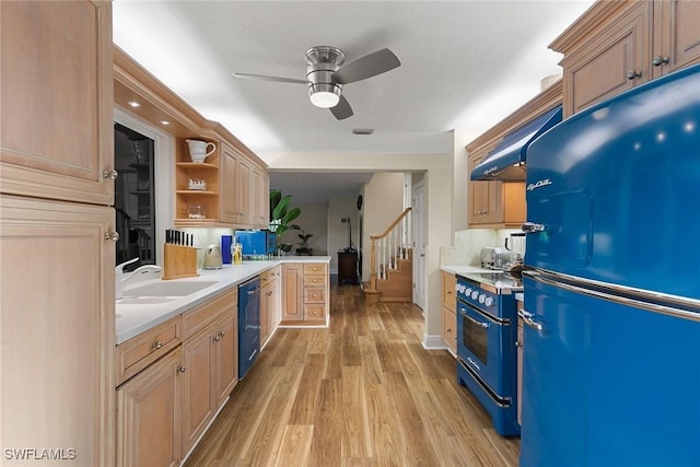 kitchen featuring light wood-type flooring, ceiling fan, sink, black appliances, and light brown cabinets