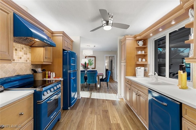 kitchen with custom exhaust hood, black appliances, sink, decorative backsplash, and light hardwood / wood-style floors