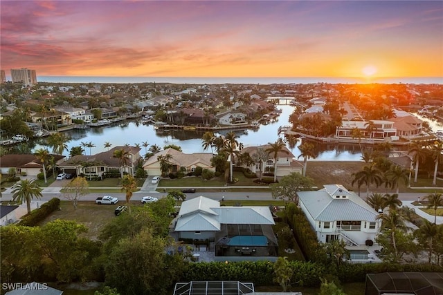 aerial view at dusk with a water view