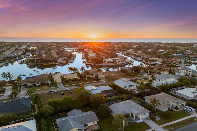 aerial view at dusk with a water view