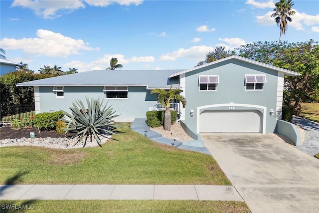 view of front facade with a front yard and a garage