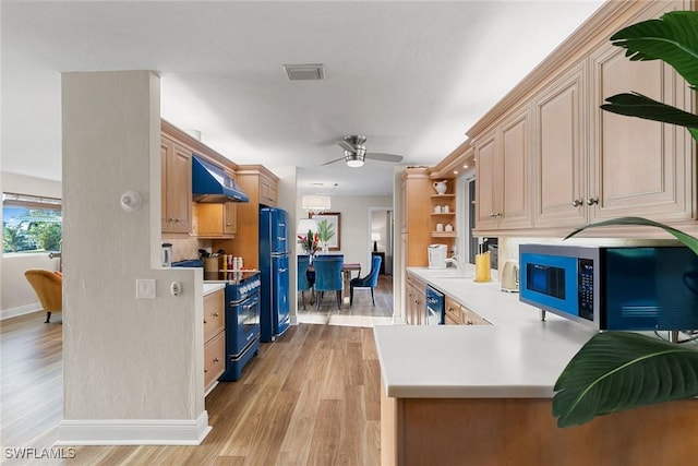 kitchen featuring ceiling fan, wall chimney range hood, kitchen peninsula, light hardwood / wood-style floors, and black appliances