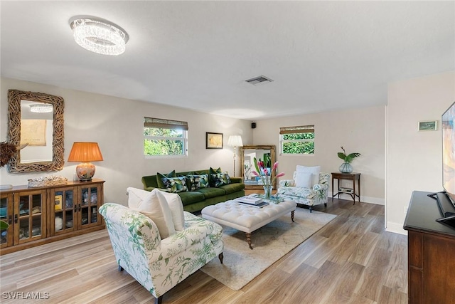 living room with light wood-type flooring and a wealth of natural light