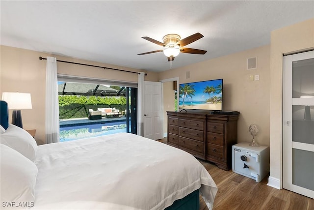 bedroom featuring access to outside, hardwood / wood-style flooring, and ceiling fan