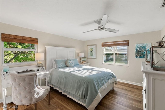 bedroom with ceiling fan and dark hardwood / wood-style flooring