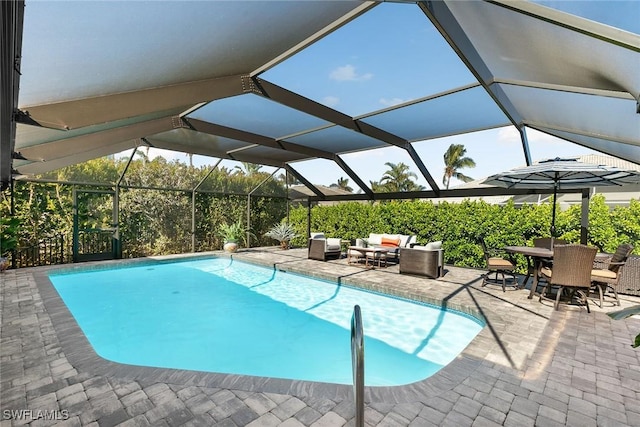 view of swimming pool featuring outdoor lounge area, a patio, and glass enclosure