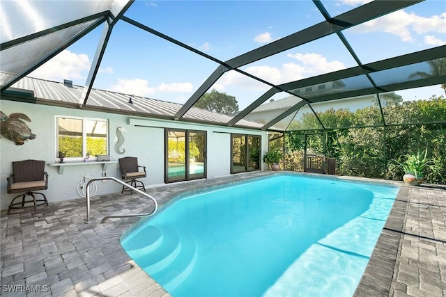 view of pool featuring a patio and glass enclosure