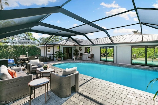 view of pool with a lanai, outdoor lounge area, and a patio area