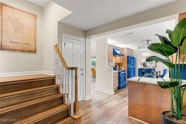 interior space with ceiling fan and light hardwood / wood-style flooring