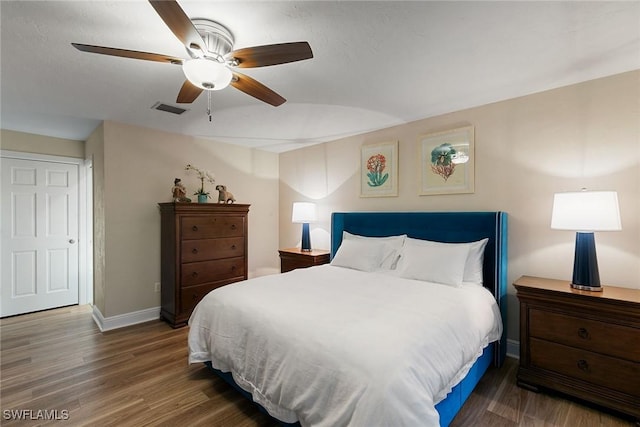 bedroom with dark wood-type flooring and ceiling fan