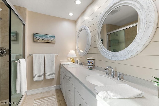 bathroom with tile patterned floors, a shower with shower door, and vanity