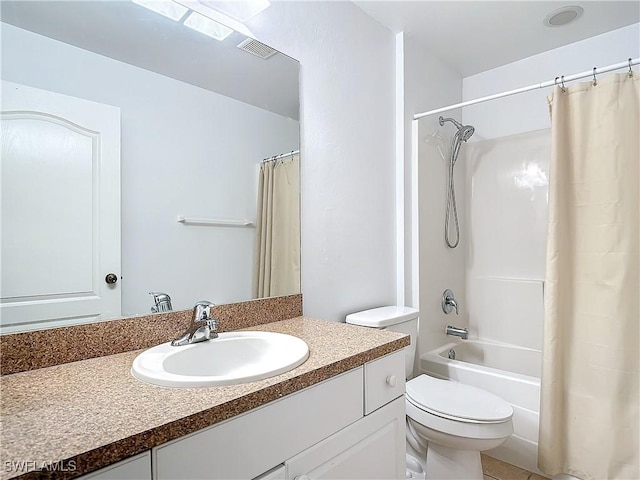 full bathroom featuring tile patterned flooring, shower / tub combo with curtain, vanity, and toilet