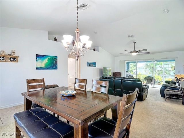 carpeted dining area with ceiling fan with notable chandelier and vaulted ceiling